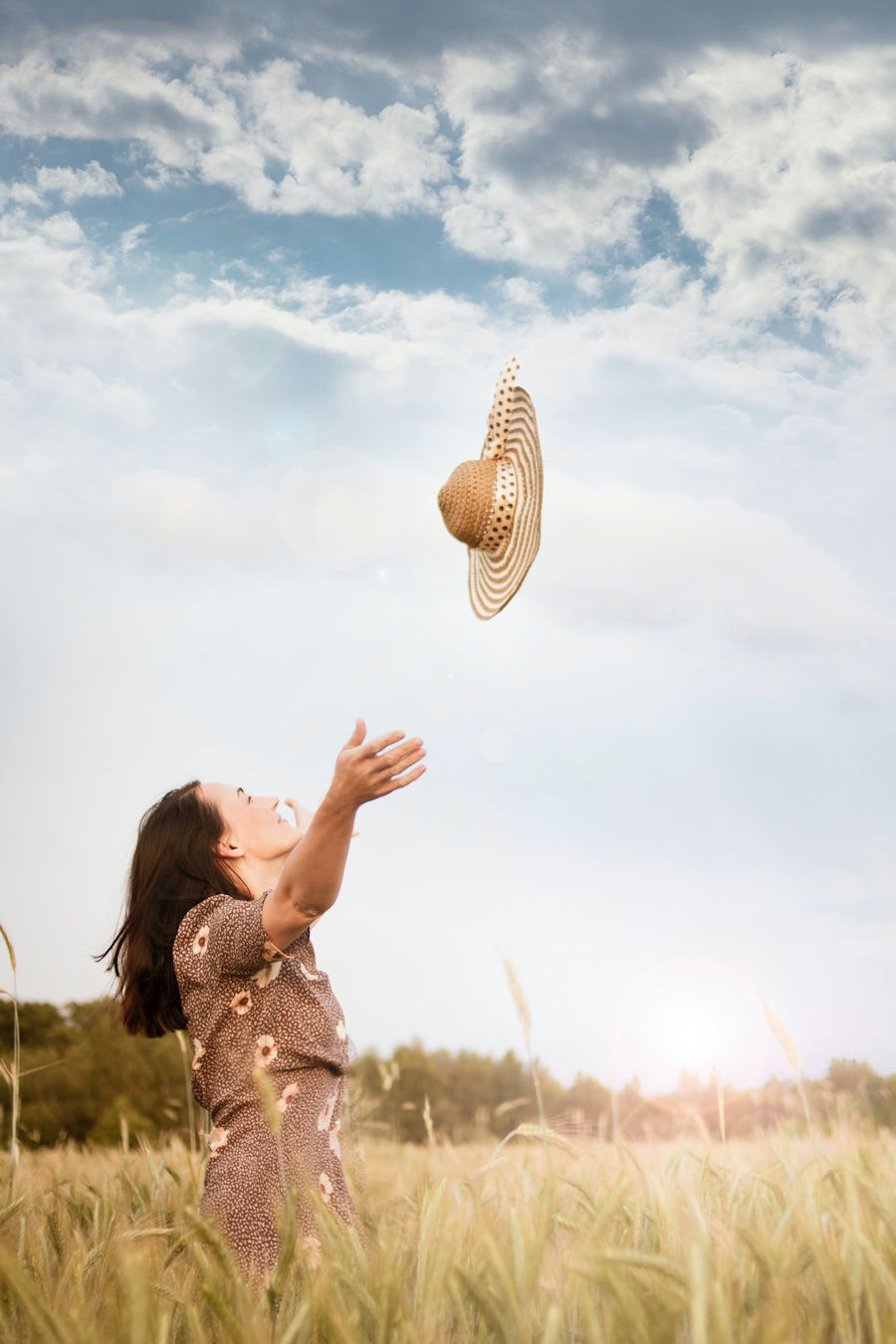 Woman throwing a hat in the air